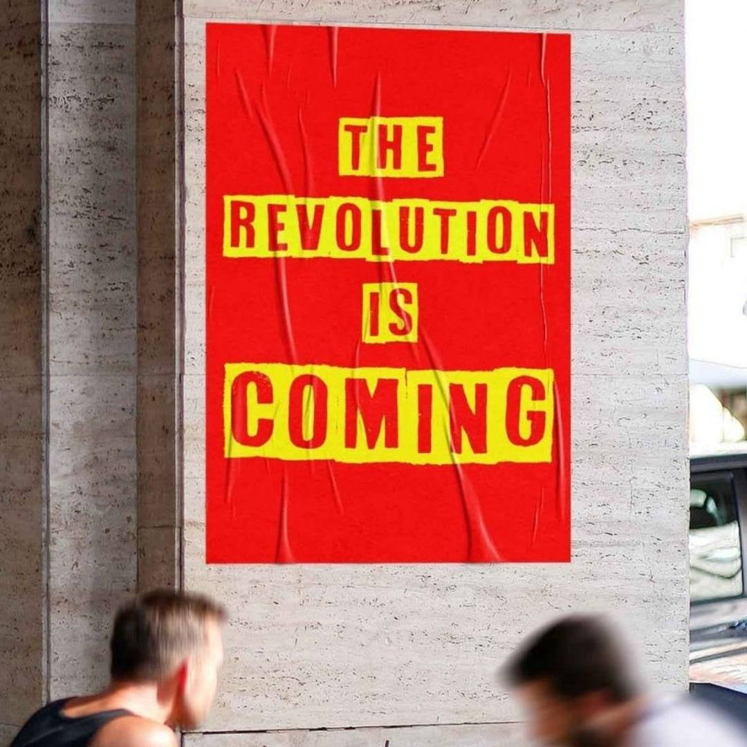 A wall print with the words The Revolution is Coming on it.