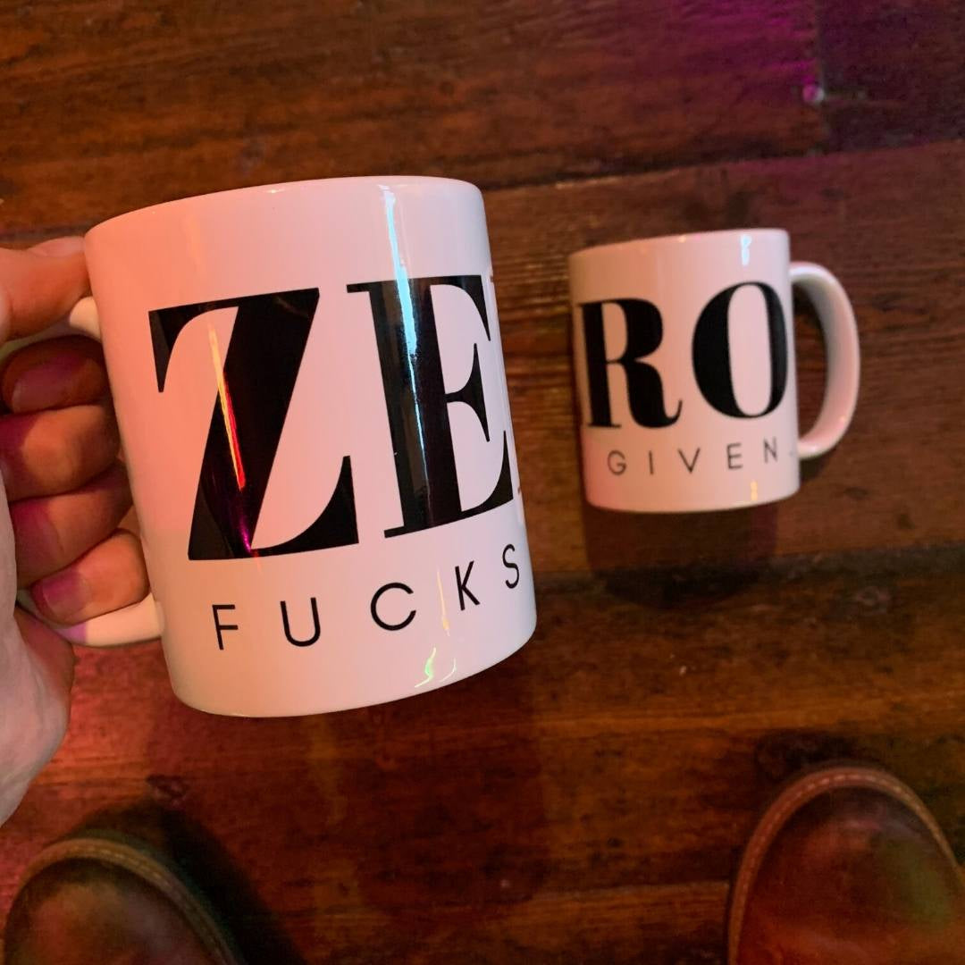 A coffee mug with the words Zero Fucks Given on it