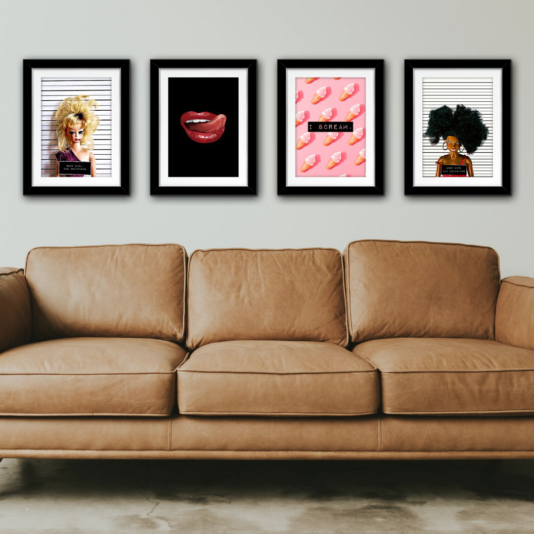 A sofa with cool frames art by Famous Rebel above it on the wall