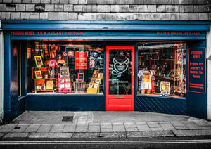 An exterior shot showing the shop front of Famous Rebel showing unique art, nome decor and lights in the window.